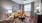 Model living room at our apartments in Aubrey, featuring wood grain floor paneling and a window with blinds and curtains.