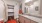 Model bathroom at our apartments in Aubrey, featuring wood grain floor paneling, granite counters, and a large mirror.